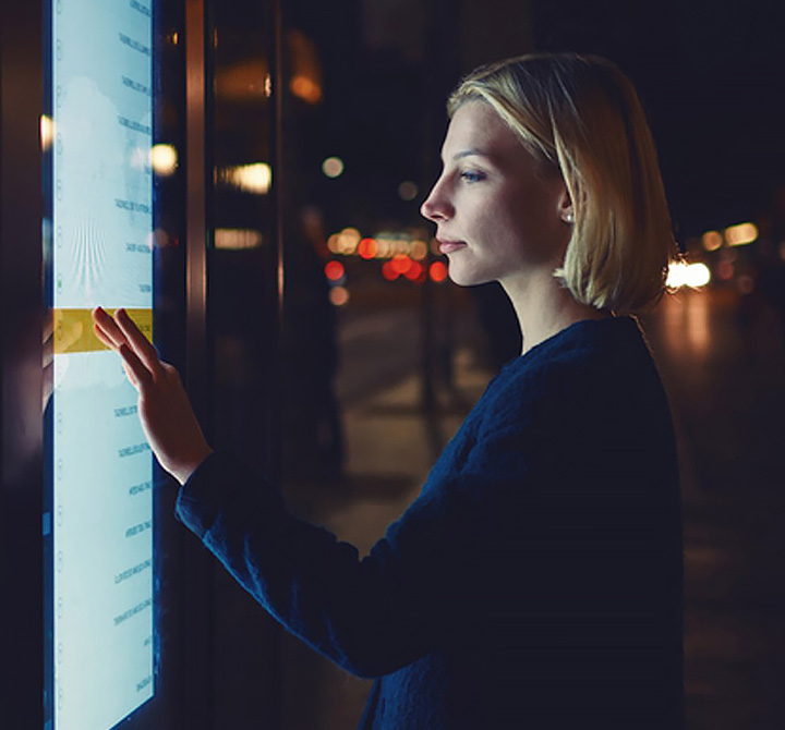 Woman using AT&T Interactive display.