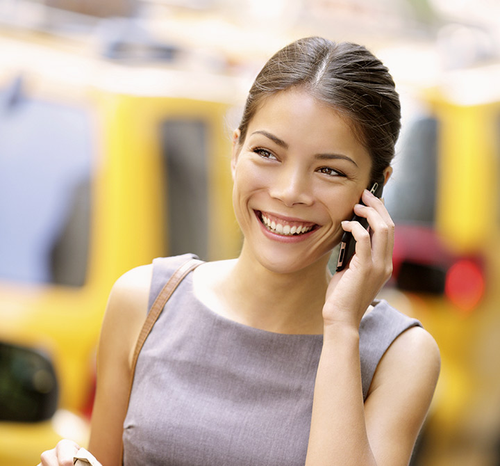 A smiling woman on her cellphone.