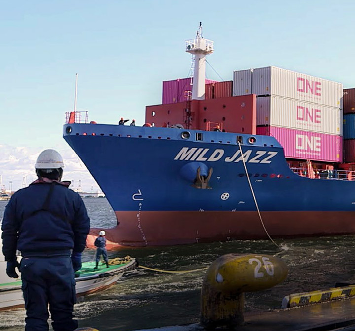 Large freight ship with shipping containers on it.
